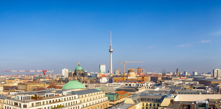 Berlin - Januar 2017: Beautiful panoramic aerial view over Berlin (Berlin Cathedral - Berliner Dom, construction site City Palace - Stadtschloss), with romantic colorful sunset.