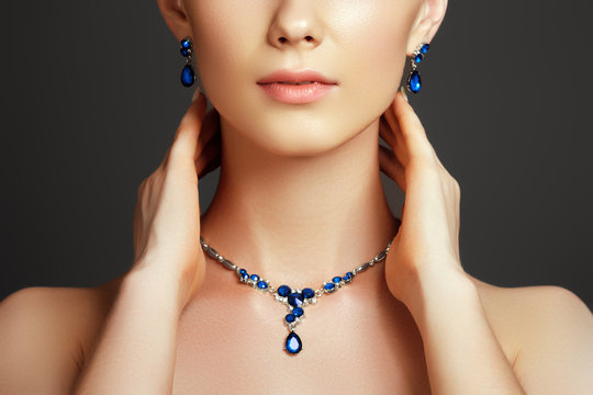 Beautiful woman with a sapphire necklace. Fashion concept