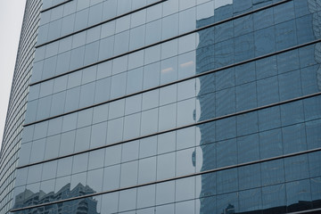 Fototapeta na wymiar Tall buildings mirroring in other construction