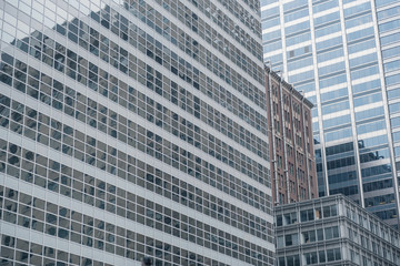 Obraz premium Different constructions mirroring in tall buildings