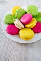 multicolored macaroons on white wooden surface