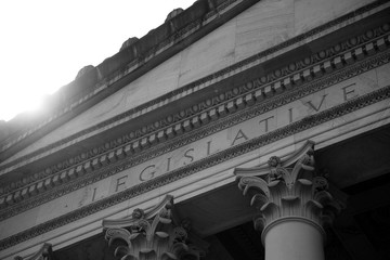 Black and white exterior of Legislative chambers of Washington State with inscription and pillars