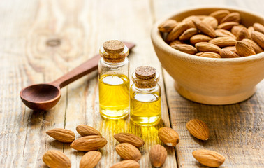 organic cosmetic with almond extract on table background