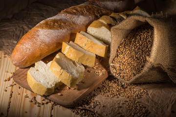 Assortment of baked bread on wooden table background