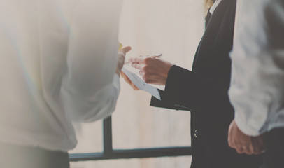 Fototapeta premium Group of coworkers discussing business strategy in modern office.Horizontal, blurred background.