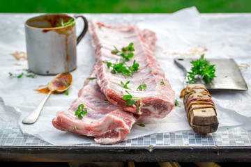 Preparing whole ribs with rosemary and spices