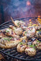 Delicious chicken on grill with spices and rosemary