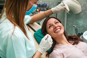 Fototapeta premium Beautiful woman smiling at the dentist's