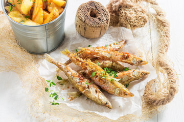Fresh smelt fish and chips with salt and herbs