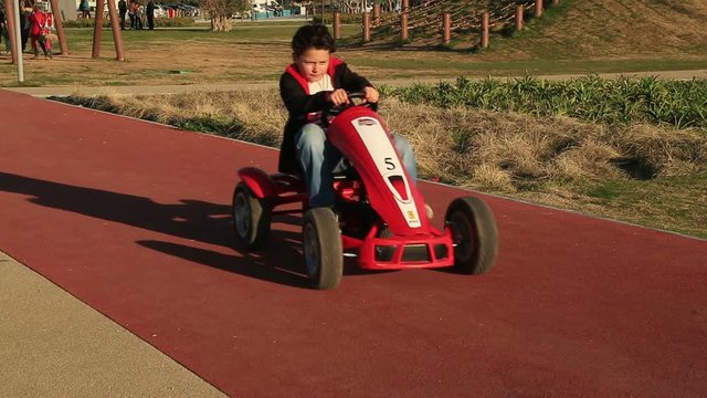 Young kid have fun on a go cart