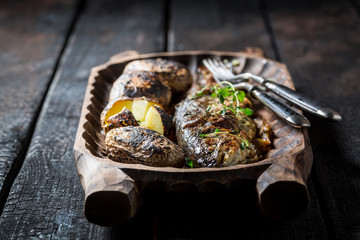 Homemade trout fish and potatoes with herbs and butter