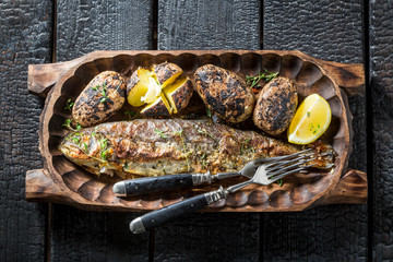 Fresh trout fish and potatoes with butter and herbs
