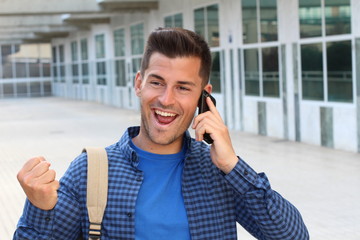 Young male getting awesome news though the phone 