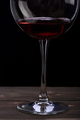 wineglass with wine on black background