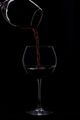 Naklejka na ściany i meble wineglasses with wine isolated on black background