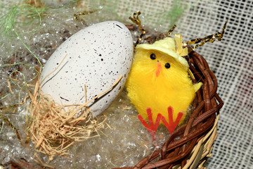 decorated egg with chick inside a wicker basket