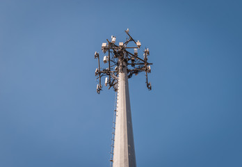 Isolated cellular radio antenna. Radio antenna with clear sky background. Industrial energy power design. Minimal design and detail. Broadcast tower. Steel beam tower. 