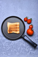 Toast on frying pan with red tomato vegetable
