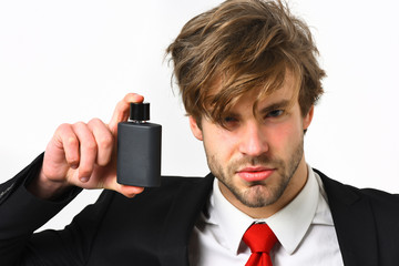 Caucasian stylish business man posing with perfume