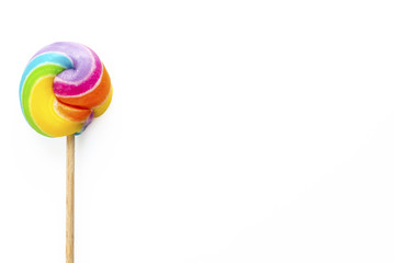 rainbow colored lollipop isolated on white background. copy space.