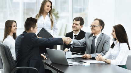 Business meeting the table and handshake of business partners