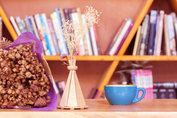 Coffee cup  with  dried flowers on wood table. © Pheniti