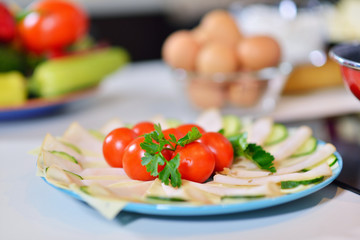 Food tray with delicious salami tomatoes, salad and vegetable