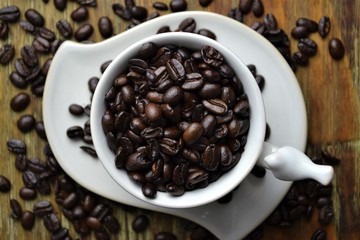 Coffee beans in white cup 