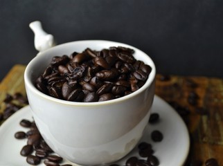 White coffee cup with coffee beans