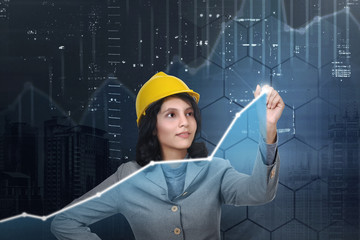Asian architect woman with yellow hat drawing virtual chart