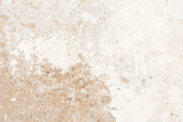 The texture of the old antique wall is white-gray-brown, part of the surface has a damaged layer of plaster, a porous part of the sand-lime base