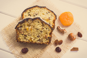 Vintage photo, Fresh baked fruitcake with ingredients on boards