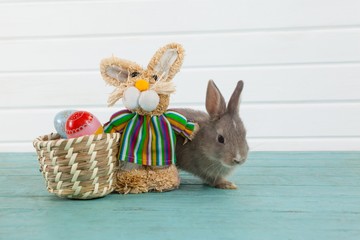 Easter eggs on wicker basket with Easter bunny and toy
