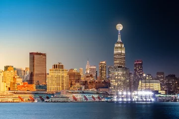 Wall murals New York Composite day to night timelapse with the full moon rising above New York City skyline.