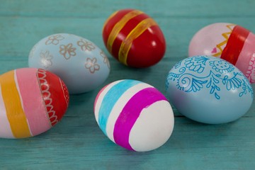 Various Easter eggs on wooden surface
