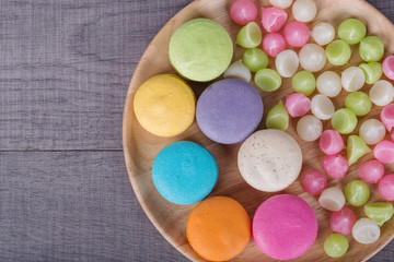 sweet colorful cake macaron and Aalaw or Alua candy in plate on wood table