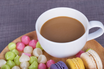 coffe with macaron and Aalaw on wood table
