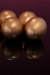 Golden Easter eggs on colored background