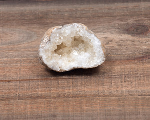 Natural raw citrine geode on vintage wooden tray background