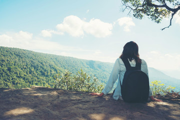 Fototapeta premium woman hiking sit down enjoy the beautiful view at mountain for sun light