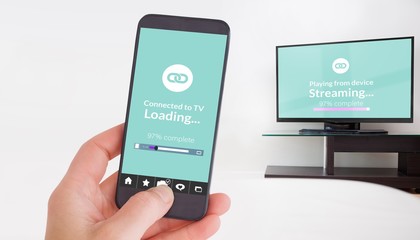 Composite image of female hand holding a smartphone