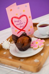 Happy mothers day greeting card with tea and snacks