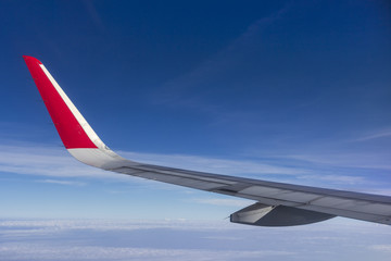Wing of the plane on blue sky background