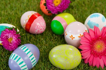 Painted easter eggs with flower on grass