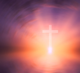 Fototapeta premium Religious cross against the background of the rays of the setting sun, symbolizing 