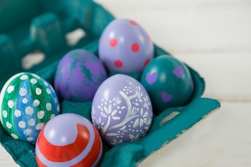 Multicolored Easter eggs in the carton