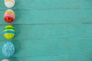Painted Easter eggs on wooden plank