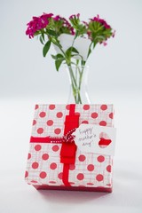 Gift box with happy mothers day tag and flower vase
