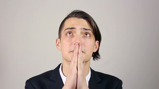 Young man praying, asking God for help.