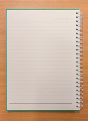 Notebook paper with on wooden background